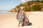Image of a woman holding Nakie's recycled sand-free beach towel in one hand, showcasing the lightweight and portable design for easy carrying. preview #11