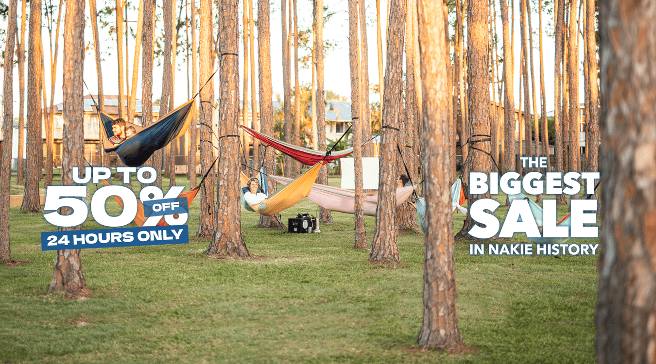 A family all relaxing in different hammocks together 