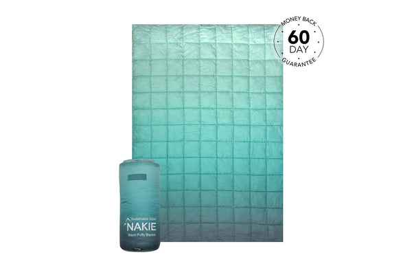 Horizon Green quilted puffy blanket with sustainable down fill, shown flat and rolled in storage bag