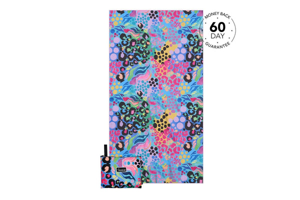 Multicolored abstract patterned beach towel with leopard spots, geometric shapes, and wavy lines in pink, blue, yellow