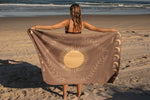 Beige recycled beach towel with gold sun and celestial design, held open on sandy beach preview #8