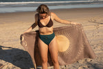 Taupe recycled beach towel with celestial sun and moon design, displayed on sand at the shore. preview #6