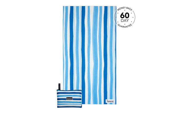 Blue and white striped recycled beach towel with compact carry pouch, flat lay view.