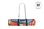 Rolled recycled picnic blanket with colorful retro fruit and stripe pattern, black carry straps and NAKIE logo label. preview #4