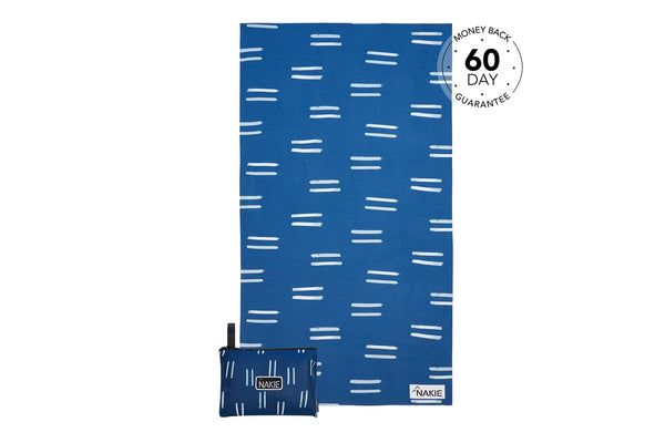 Blue recycled beach towel with white dash pattern, shown flat with matching small pouch.