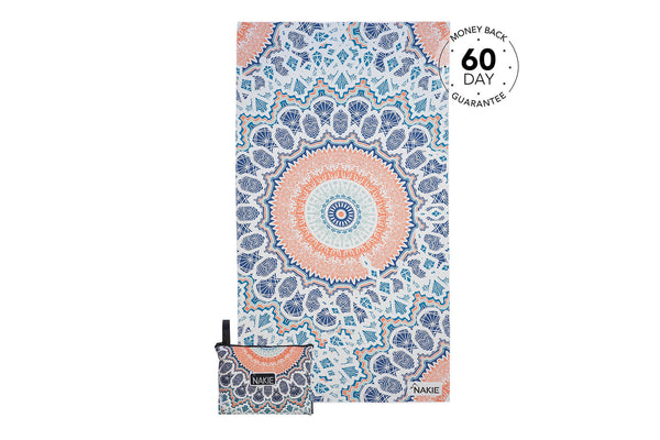 Recycled sand-free beach towel with blue, coral, and cream mandala pattern, shown flat lay with carrying pouch.