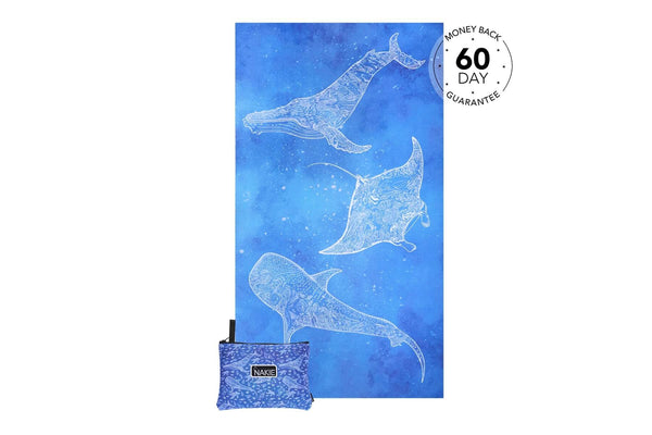 Blue beach towel with white line-art whales and manta rays, shown folded with matching carrying pouch